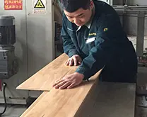 The quality inspector test the splicing gap of flooring second time